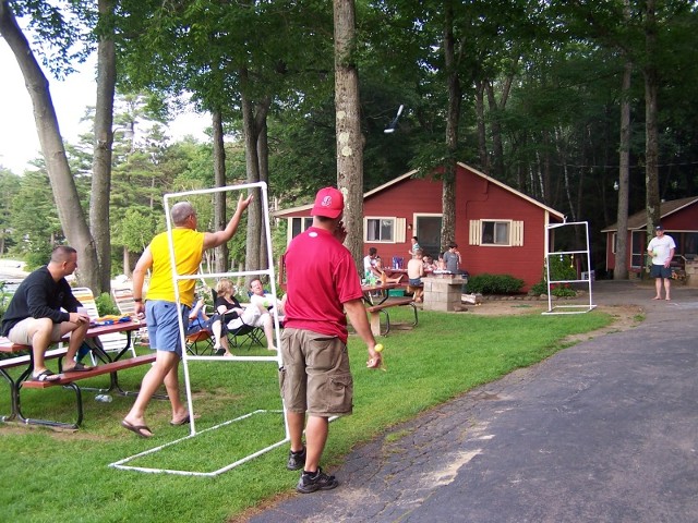 Two person moving a metal stand