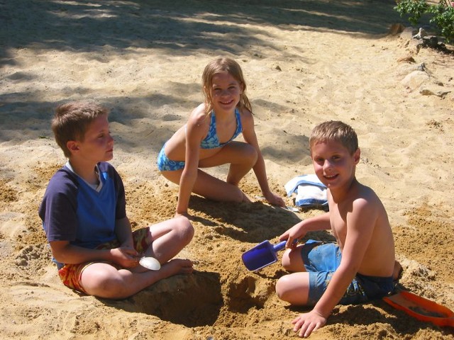 3 Kids playing in the sand